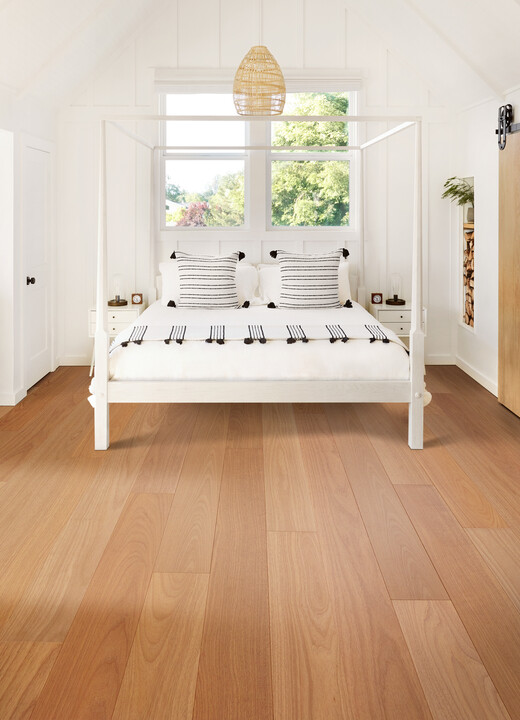 hardwood flooring in bedroom with four post bed